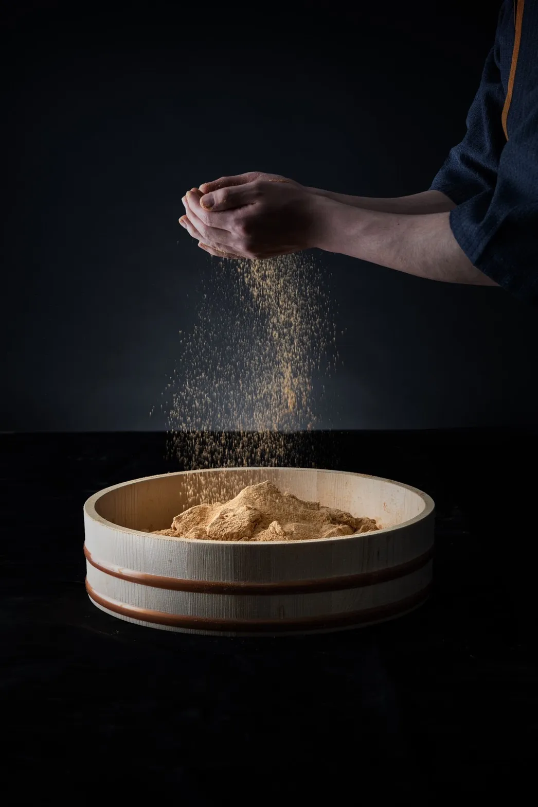 職人がきな粉をわらび餅に振りかける製造シーン