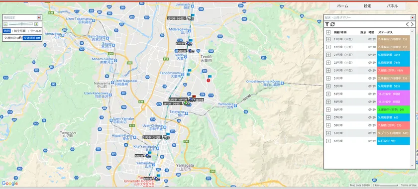 山形市周辺の道路地図上に複数の生コン運搬車両をリアルタイム表示した管理画面。右側パネルに11号〜62号車の車番・発振時刻・スランプ値・ステータス（色分け）が一覧表示