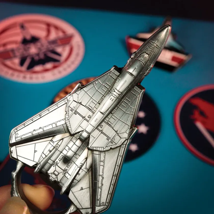 TOP GUN公式F-14戦闘機型キーホルダーの手持ちクローズアップ。シルバー地に機体パネルラインの精密刻印が確認できる立体造形ショット