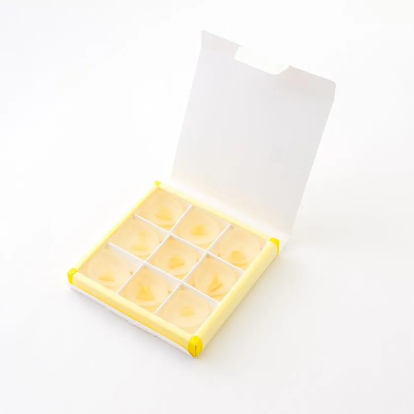 「レモンの雫」9個入り化粧箱を蓋開き状態で撮影。黄色トレーに3×3配列で並ぶ水滴形琥珀糖の収納仕様がわかるショット