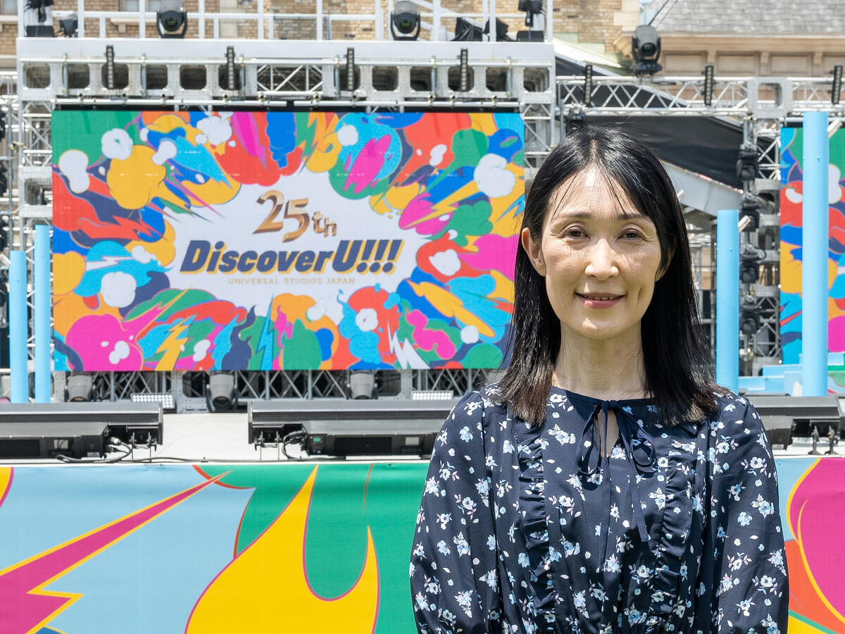 25周年ステージを背景にした久保智子の単独ポートレート