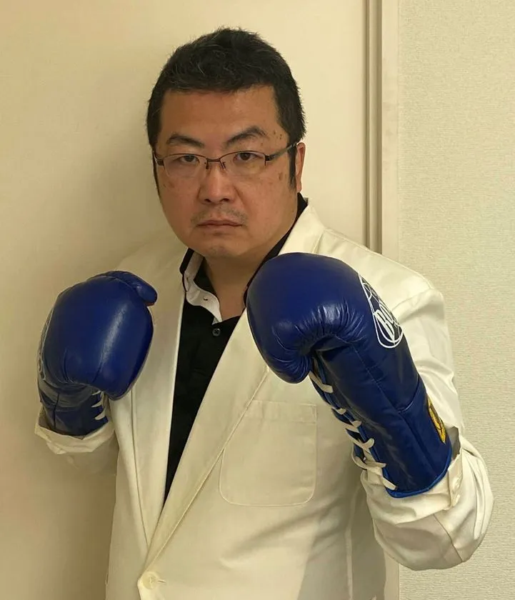白衣姿でグローブを構える鈴木宏院長