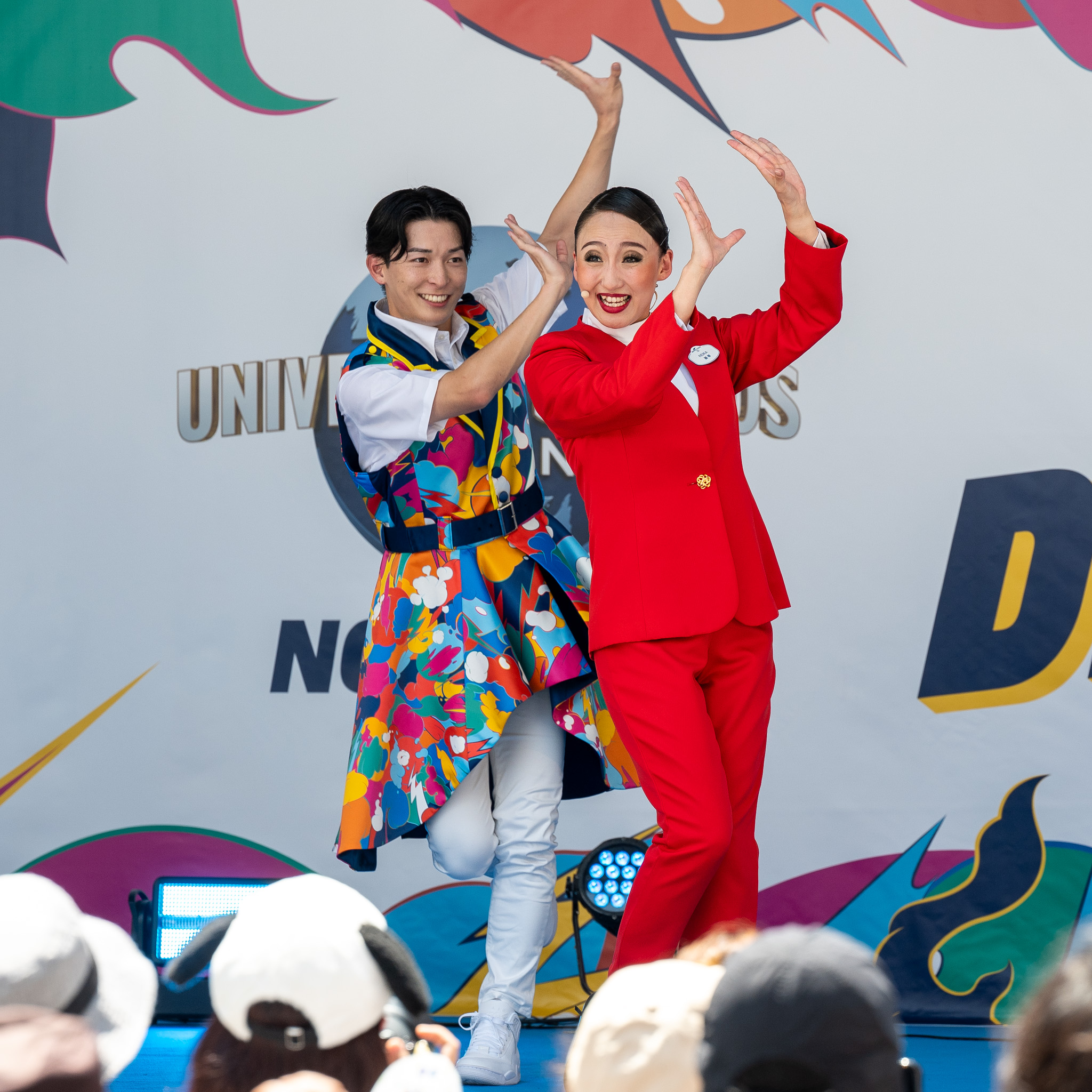 両手を頭上で合わせる綾小路麗華とエンターテイナー