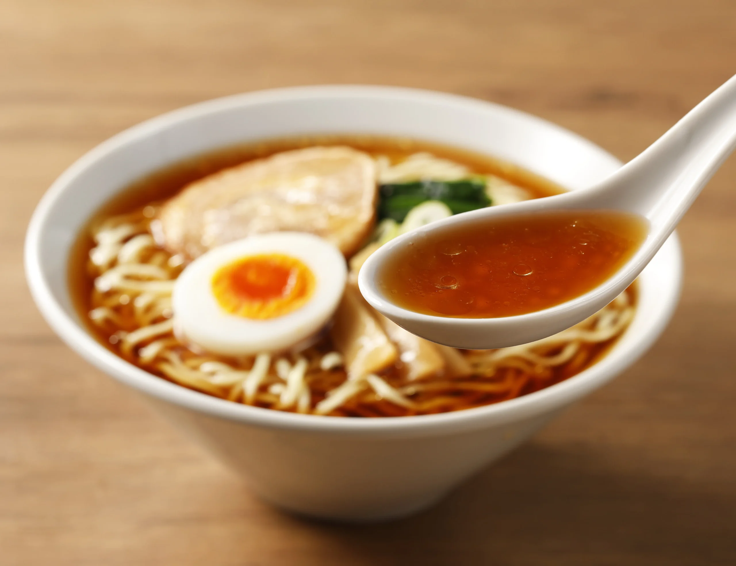 レンゲですくった醤油味のスープ