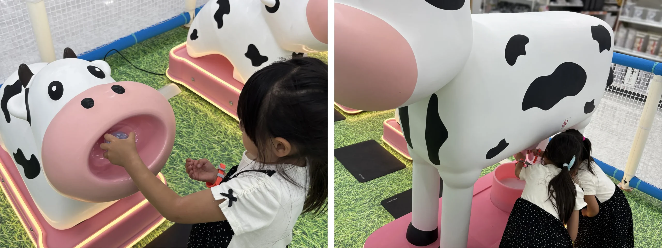 牧場コーナーで牛のオブジェにミルクをあげる子ども