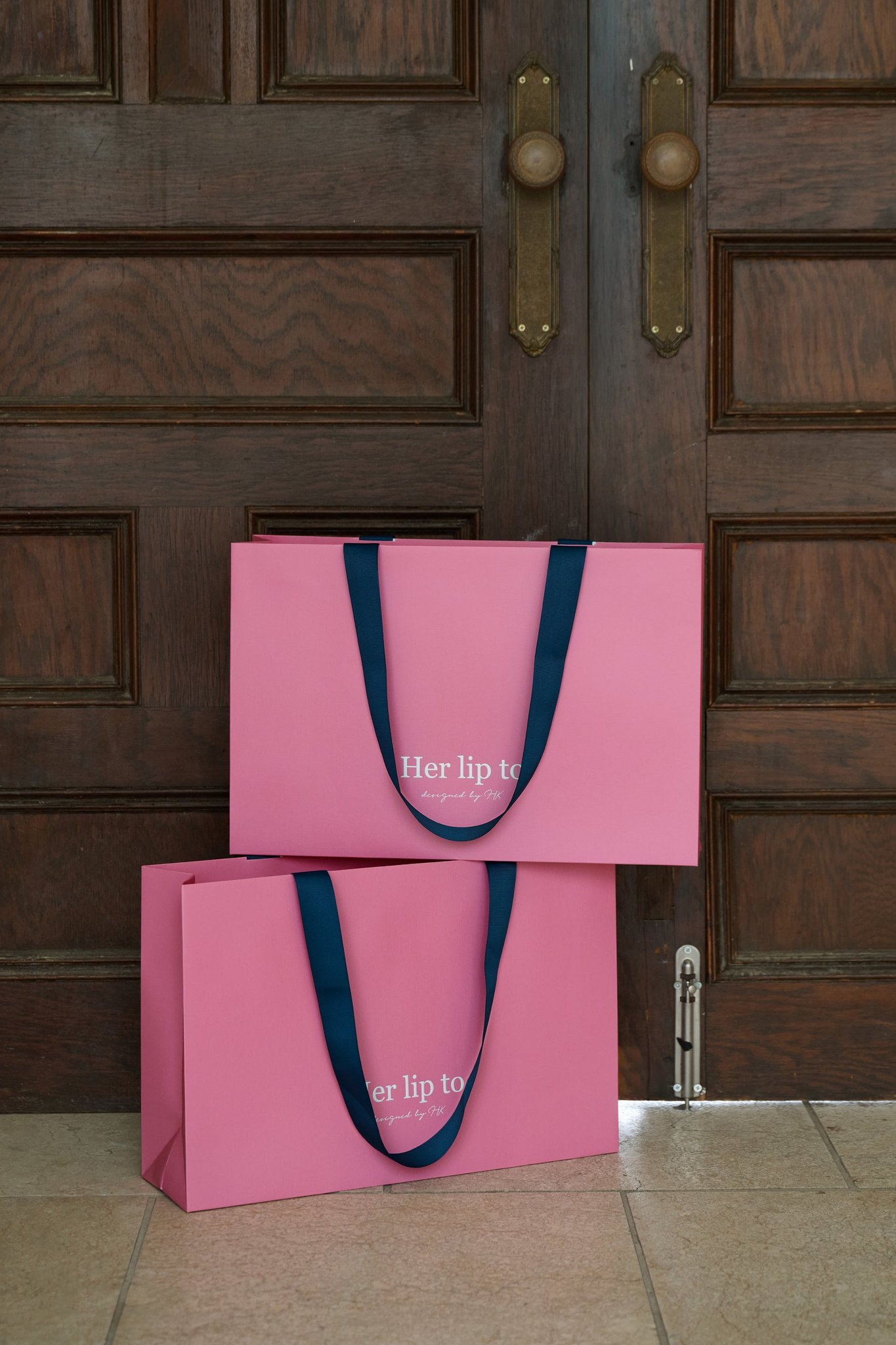 Her lip to 大阪店限定カラーのショッピングバッグ