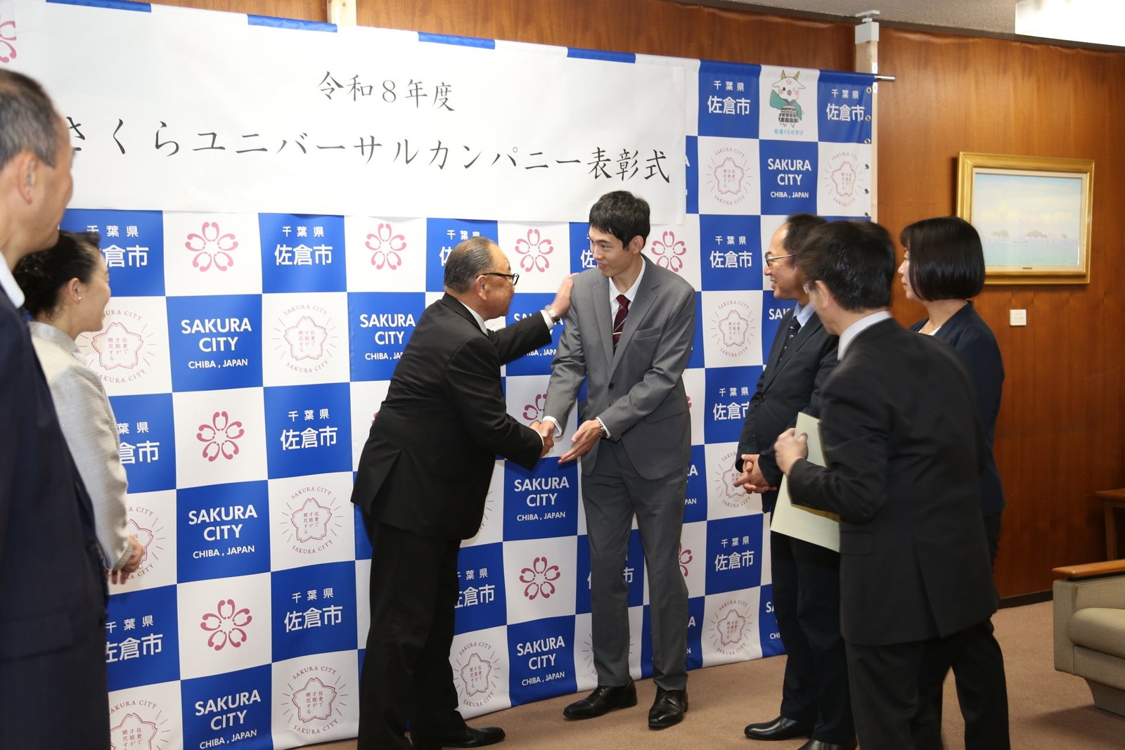 表彰式で握手する様子
