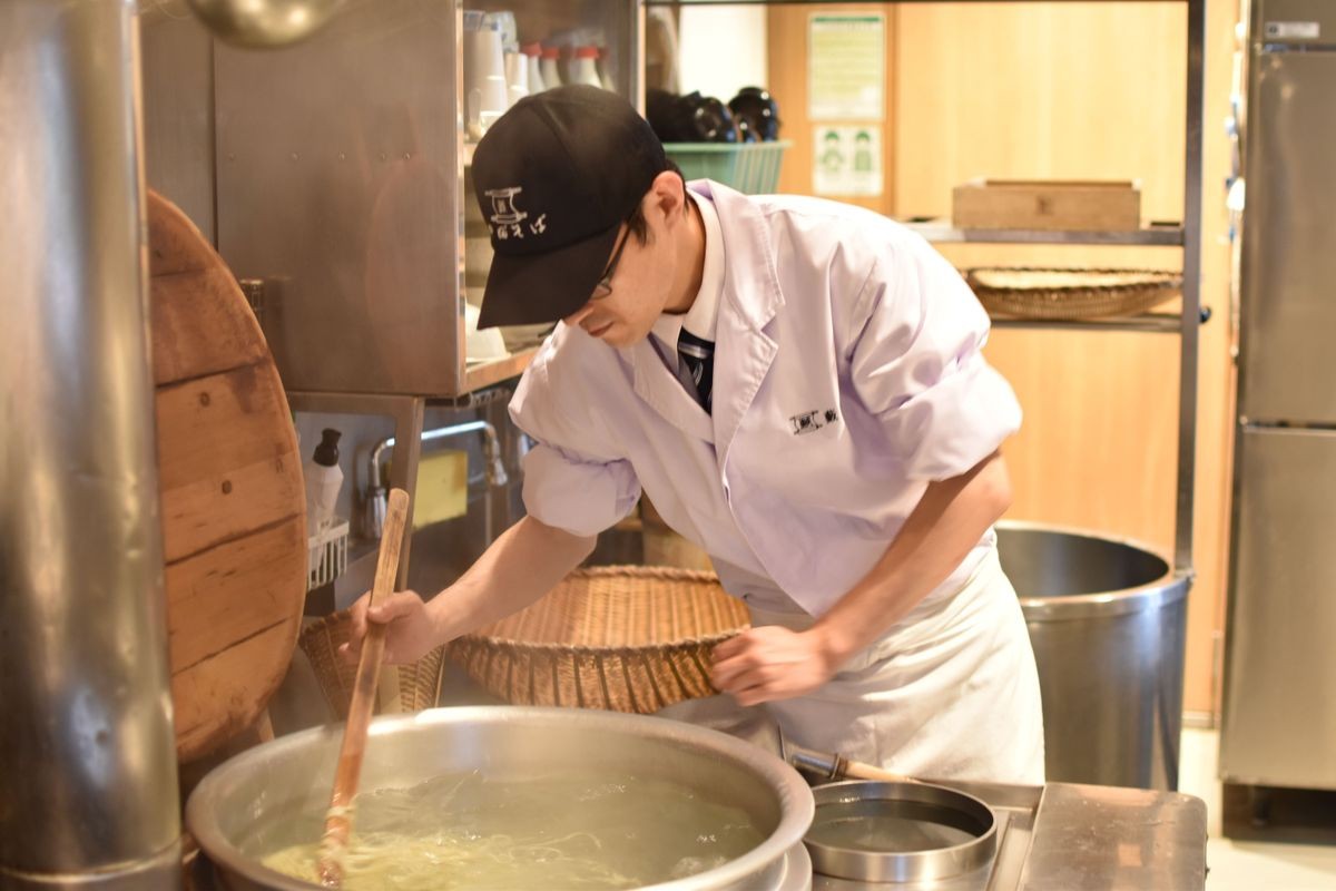 釜でそばを茹でる職人